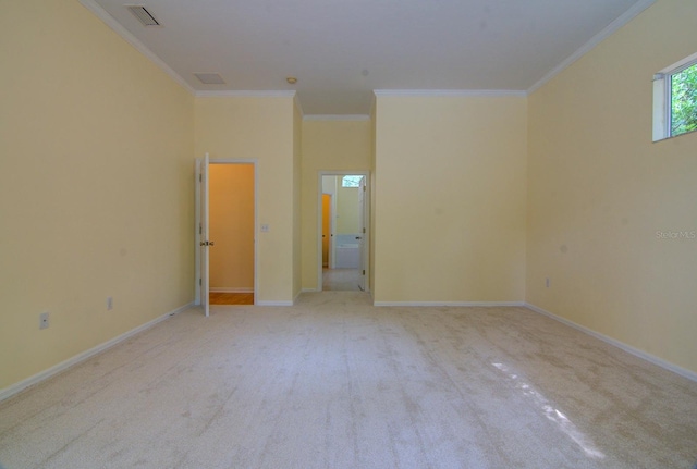 carpeted spare room with crown molding