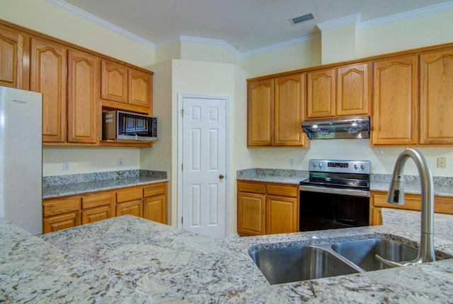 kitchen with light stone countertops, appliances with stainless steel finishes, sink, and crown molding