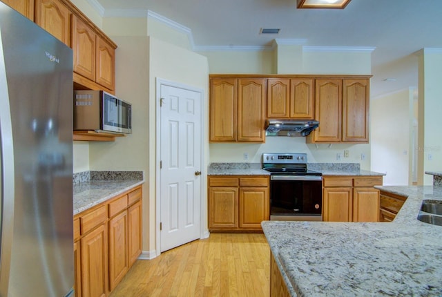 kitchen with appliances with stainless steel finishes, light hardwood / wood-style floors, ornamental molding, and light stone countertops