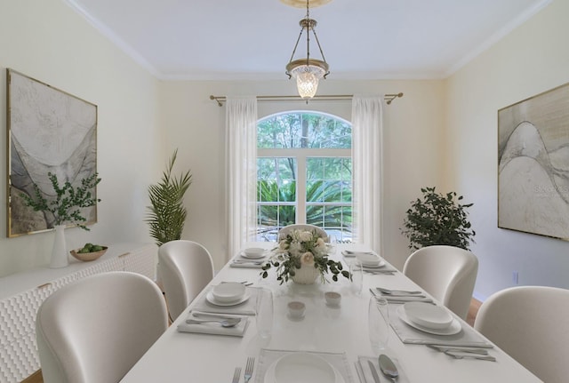 dining space featuring an inviting chandelier and ornamental molding