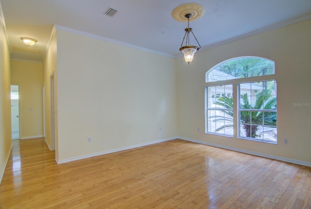 unfurnished room featuring ornamental molding and light hardwood / wood-style floors