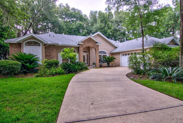 ranch-style house with a garage and a front lawn