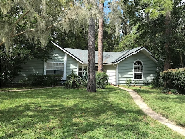 ranch-style house with a front lawn