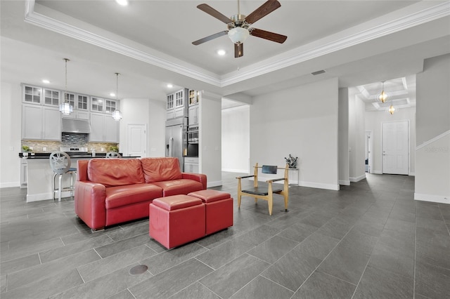 tiled living room featuring ornamental molding, ceiling fan, and a raised ceiling