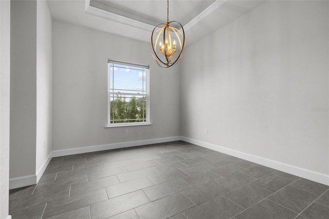 empty room featuring crown molding, a chandelier, and a tray ceiling