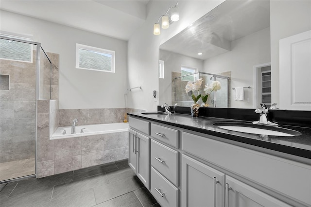 bathroom featuring vanity, tile patterned flooring, and plus walk in shower