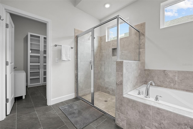 bathroom featuring tile patterned floors, a wealth of natural light, and plus walk in shower