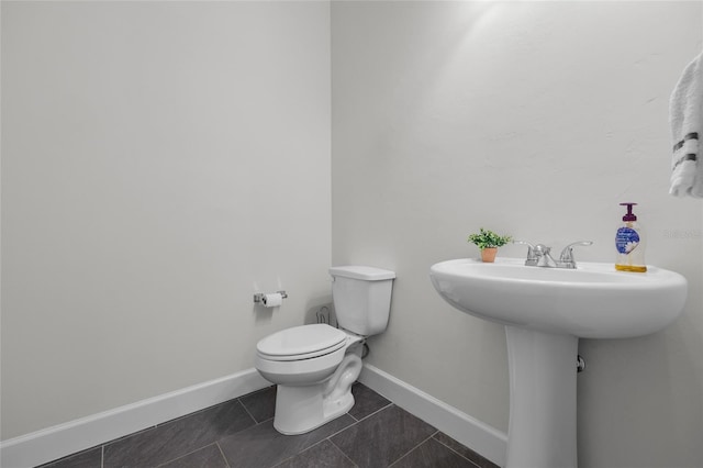 bathroom featuring toilet and tile patterned floors