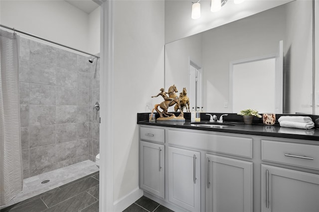 bathroom with vanity, a shower with curtain, toilet, and tile patterned flooring