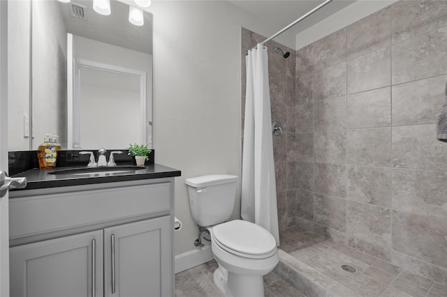 bathroom featuring vanity, toilet, and walk in shower