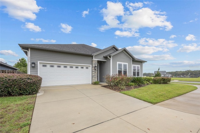 view of front facade with a front yard and a garage