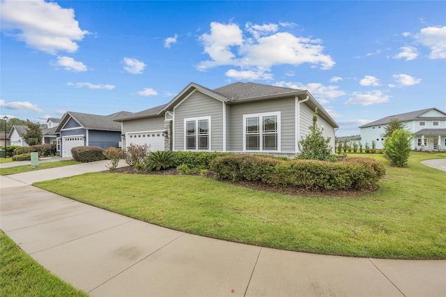 view of front of house featuring a front yard and a garage