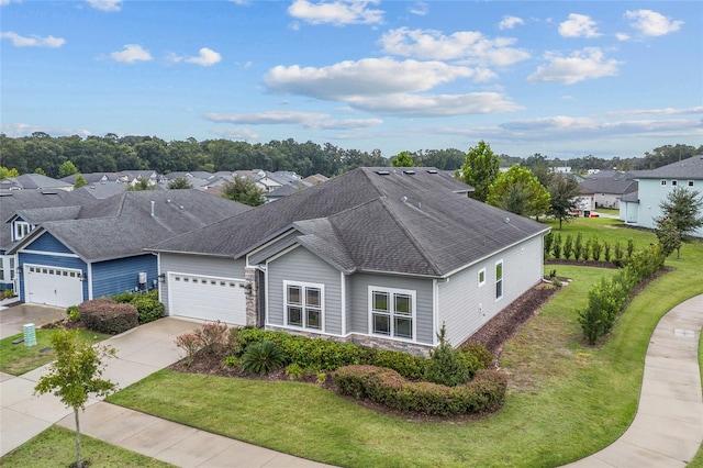 ranch-style house featuring a garage and a front lawn