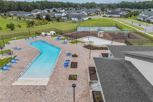 view of swimming pool with a yard, a patio area, and a playground