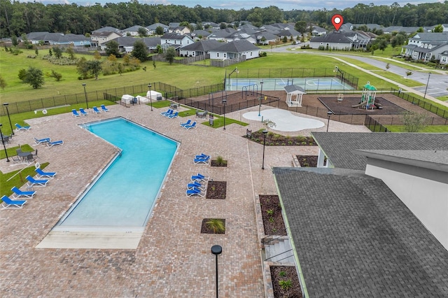 view of swimming pool featuring a patio area, a playground, and a yard