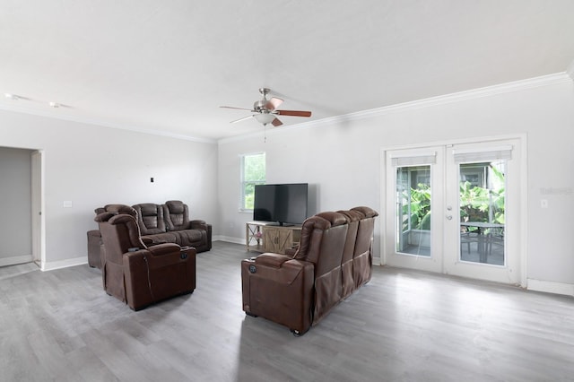 living room featuring ornamental molding, ceiling fan, light hardwood / wood-style floors, and french doors