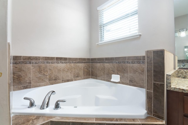 bathroom featuring vanity and tiled bath