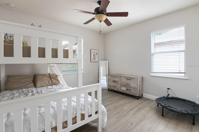 bedroom with light wood-type flooring and ceiling fan