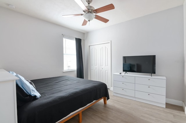 bedroom featuring ceiling fan, a closet, and light hardwood / wood-style flooring