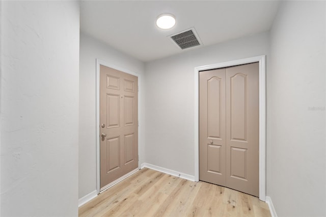 doorway with light wood-type flooring