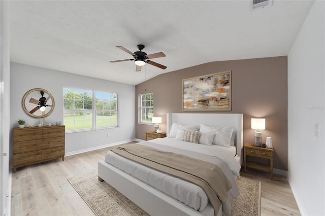 bedroom with light hardwood / wood-style flooring, lofted ceiling, and ceiling fan