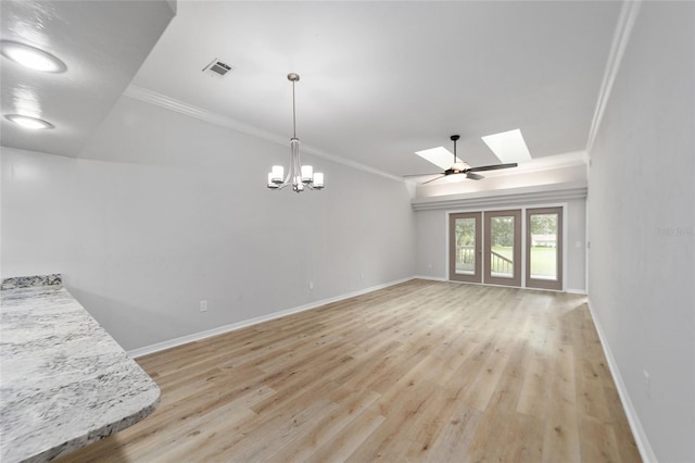 interior space featuring a skylight, ceiling fan with notable chandelier, light hardwood / wood-style floors, and crown molding