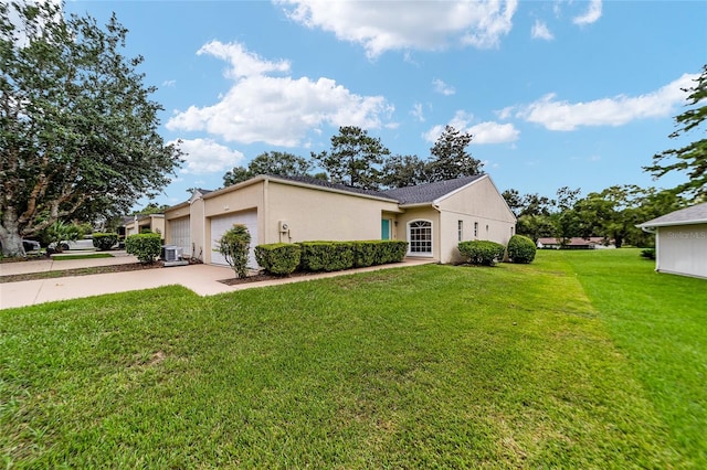 single story home with central air condition unit, a garage, and a front yard