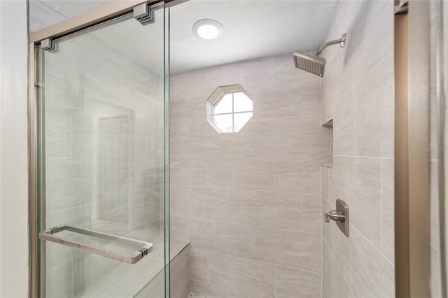 bathroom featuring a shower with door