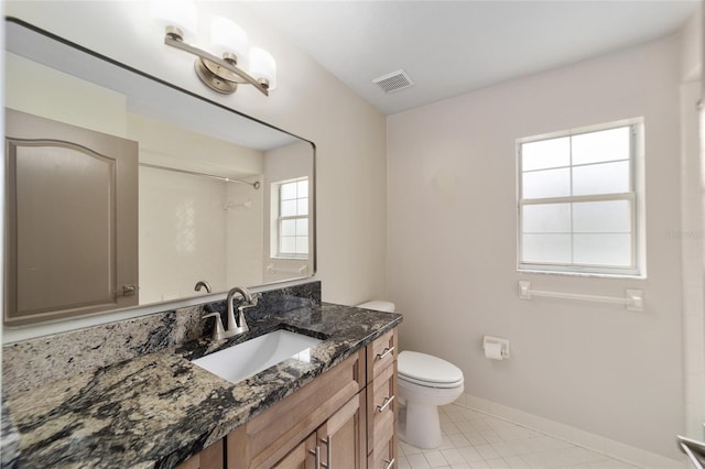 bathroom with walk in shower, tile patterned flooring, vanity, and toilet