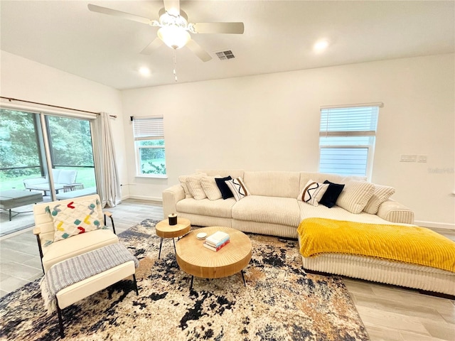 living room featuring ceiling fan and light wood-type flooring