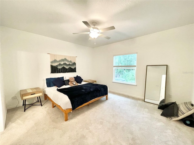 bedroom with ceiling fan and carpet flooring