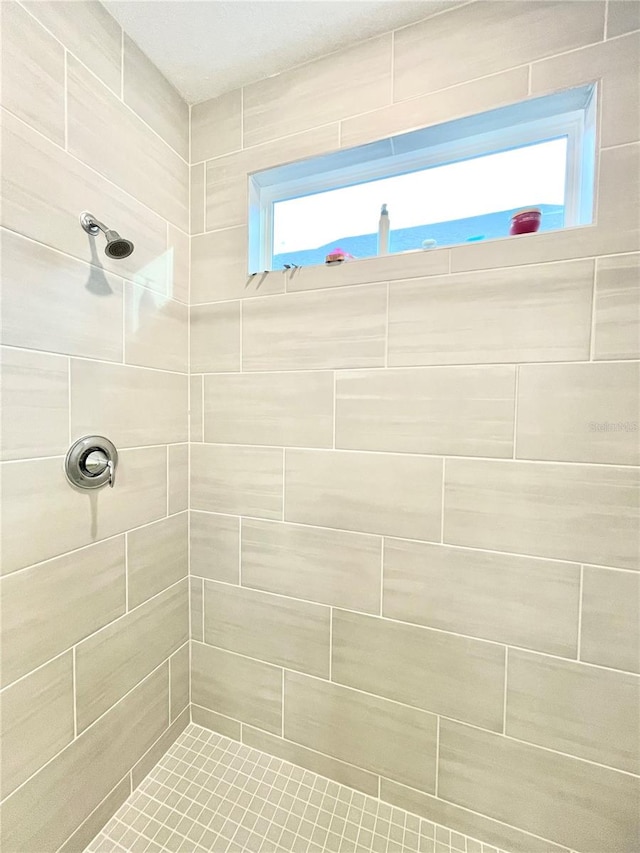 bathroom with a tile shower