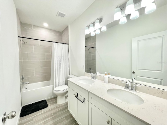 full bathroom with shower / bath combination with curtain, vanity, and toilet