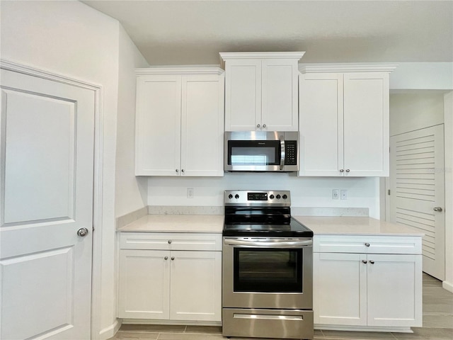 kitchen with stainless steel appliances and white cabinets