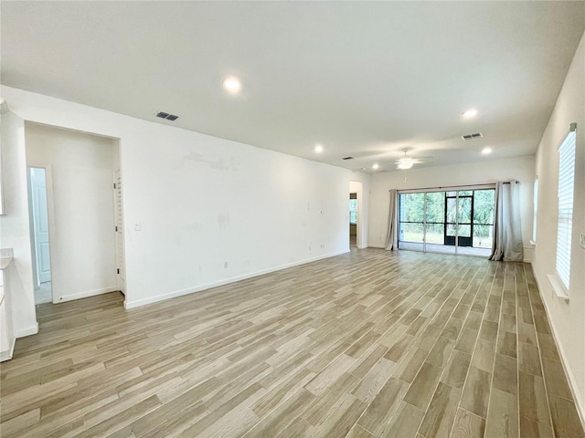 unfurnished living room featuring ceiling fan and light hardwood / wood-style floors