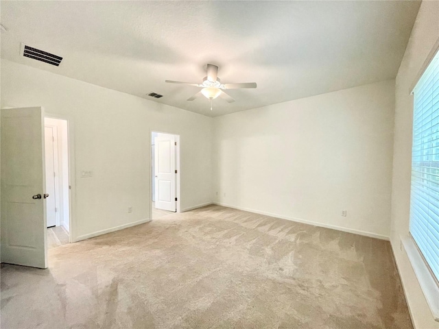 carpeted empty room featuring ceiling fan