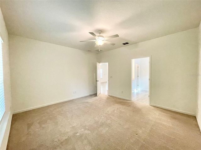 carpeted empty room with ceiling fan