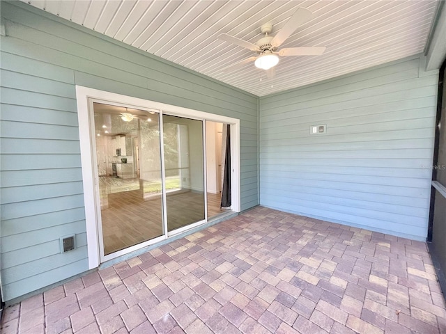 unfurnished sunroom with ceiling fan