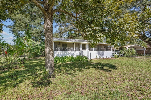 exterior space featuring a carport and a sunroom