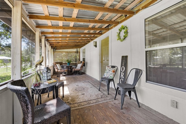 sunroom featuring lofted ceiling