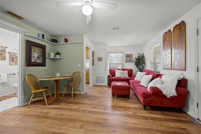 living room featuring hardwood / wood-style flooring and ceiling fan