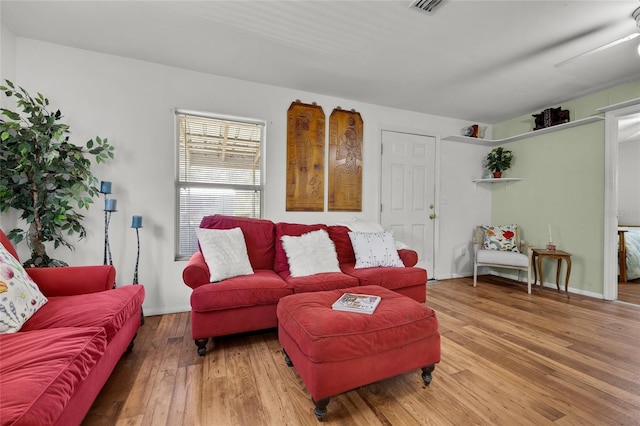 living room featuring hardwood / wood-style flooring and ceiling fan