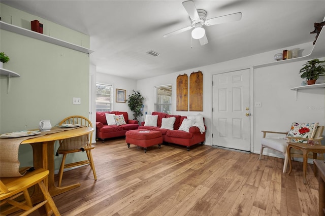 living room featuring ceiling fan and light hardwood / wood-style flooring