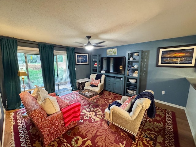 living room featuring ceiling fan, wood-type flooring, and a textured ceiling