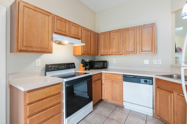 kitchen with light tile patterned flooring, white appliances, and sink