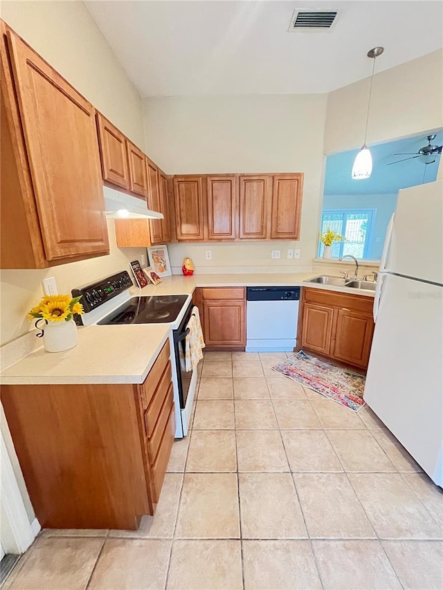 kitchen with light tile patterned flooring, sink, decorative light fixtures, ceiling fan, and white appliances