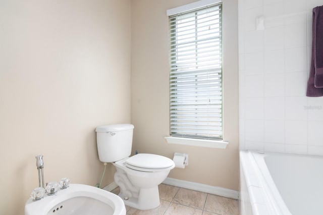 bathroom featuring tile patterned flooring, a bidet, a bath, and toilet