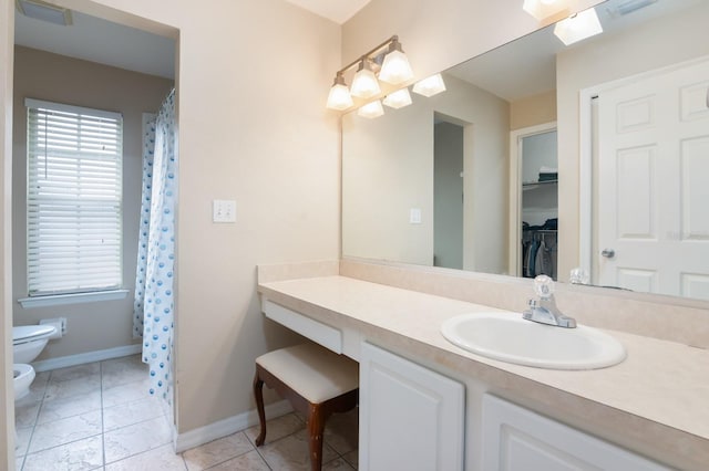 bathroom featuring a bidet, tile patterned floors, toilet, and vanity