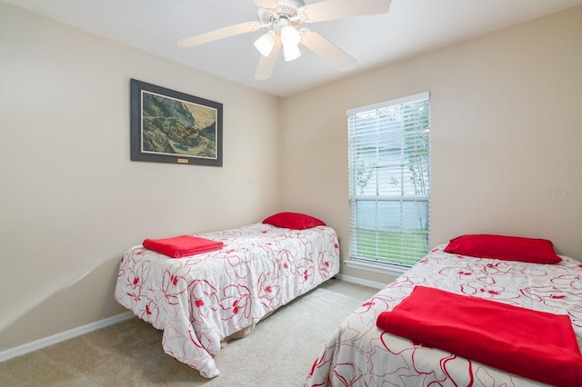 carpeted bedroom featuring ceiling fan and multiple windows