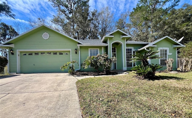 view of front of house with a front lawn and a garage